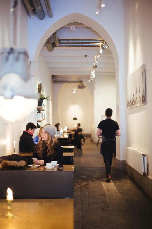 a bunch of people are sitting around eating in a restaurant