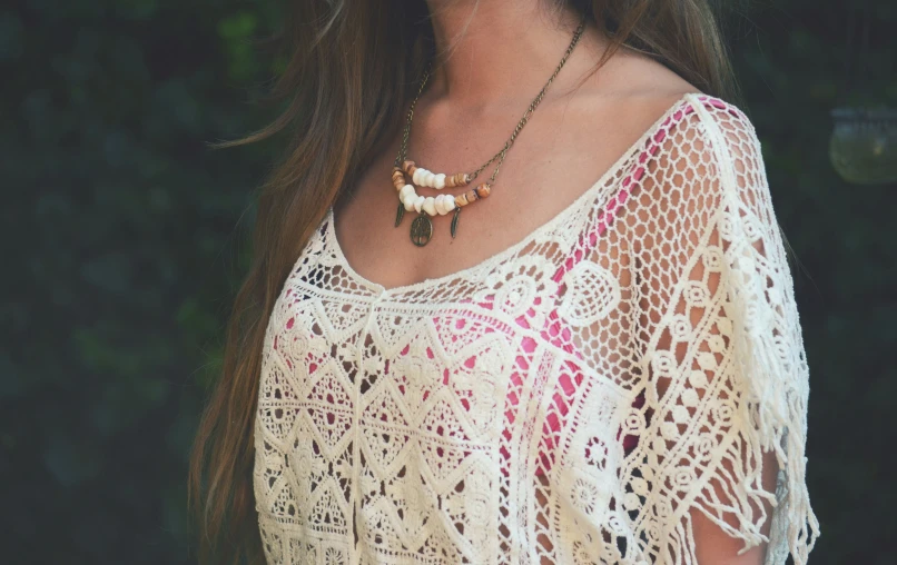 close up image of a woman wearing necklace on her neck