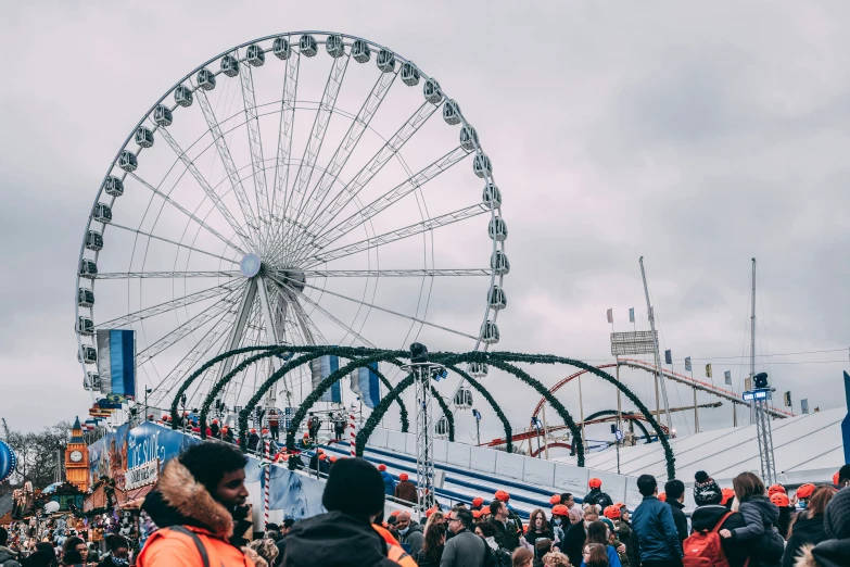 people standing around a carnival ride and some rides