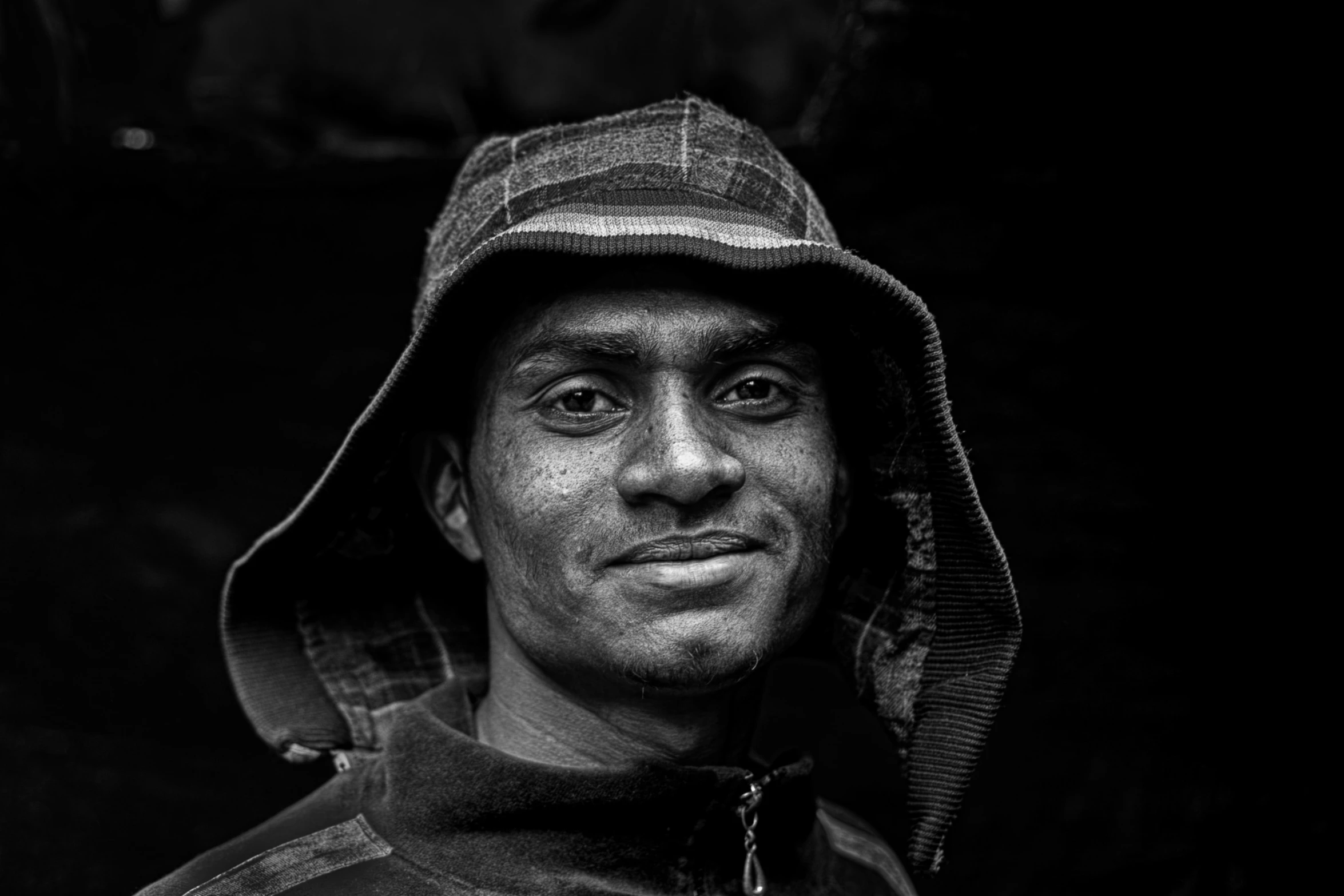 the black and white po of a man in a hoodie