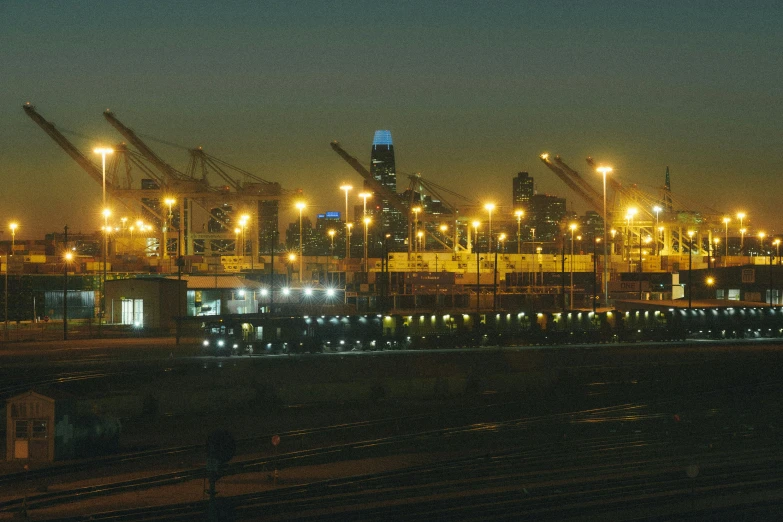 the night skyline as seen from across the train tracks