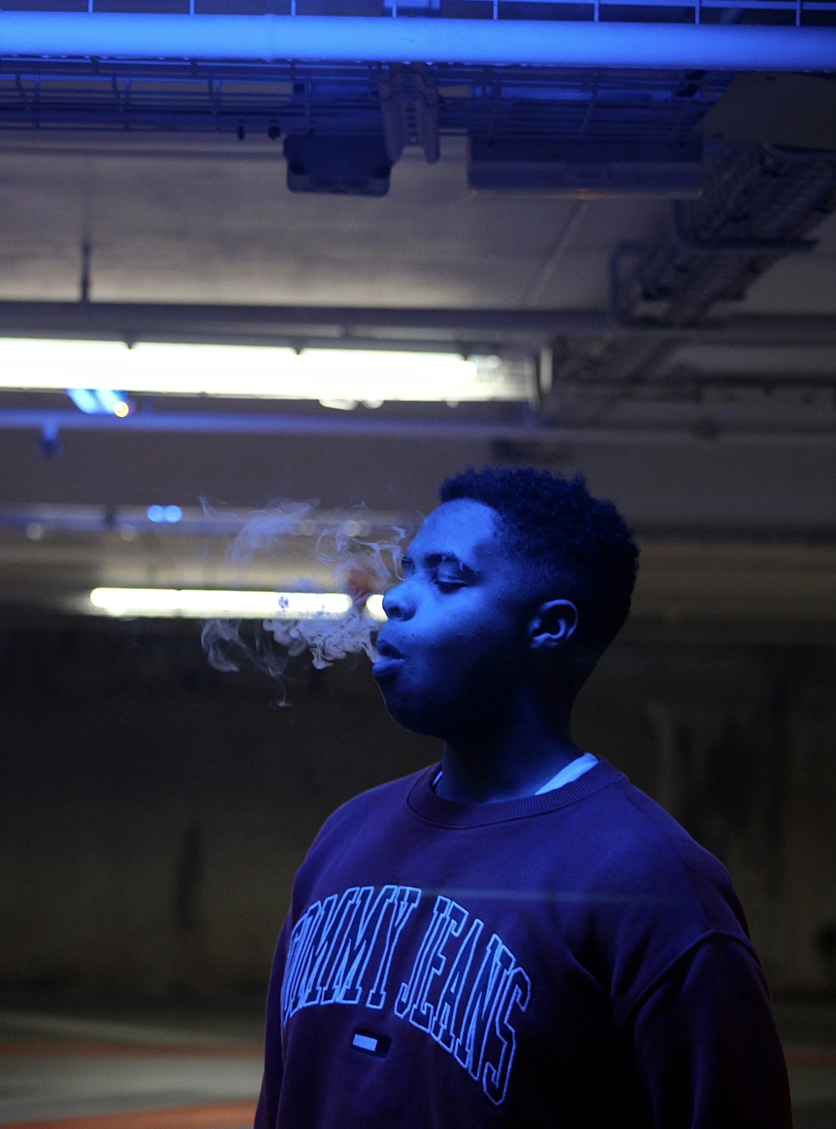 man smoking cigarette with fire on the ceiling