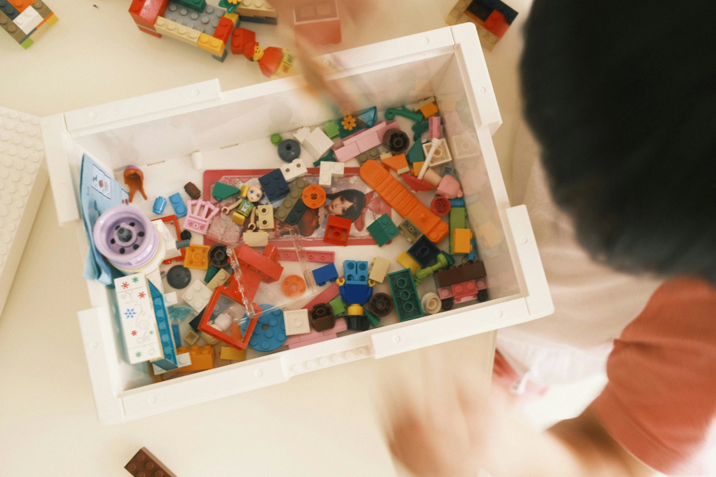 a boy is playing with some toys on the table