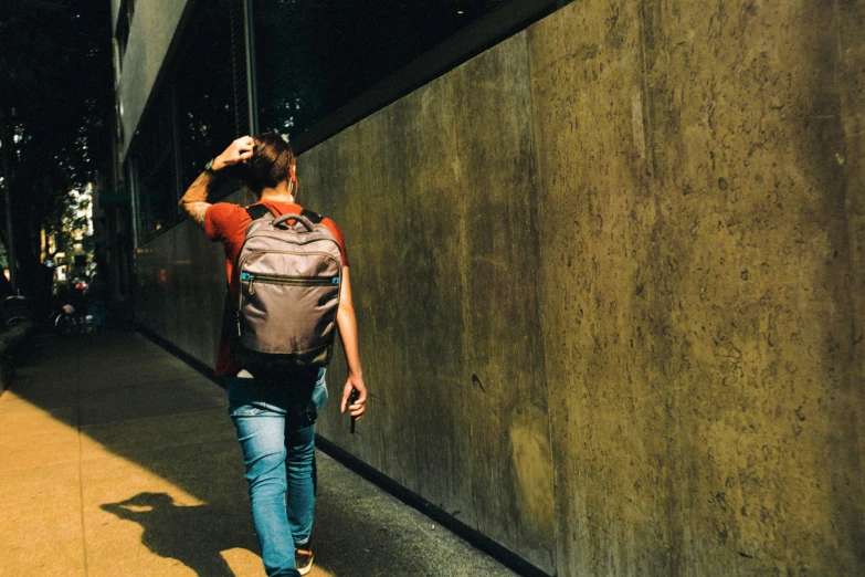 a woman walks through the streets in the sunlight