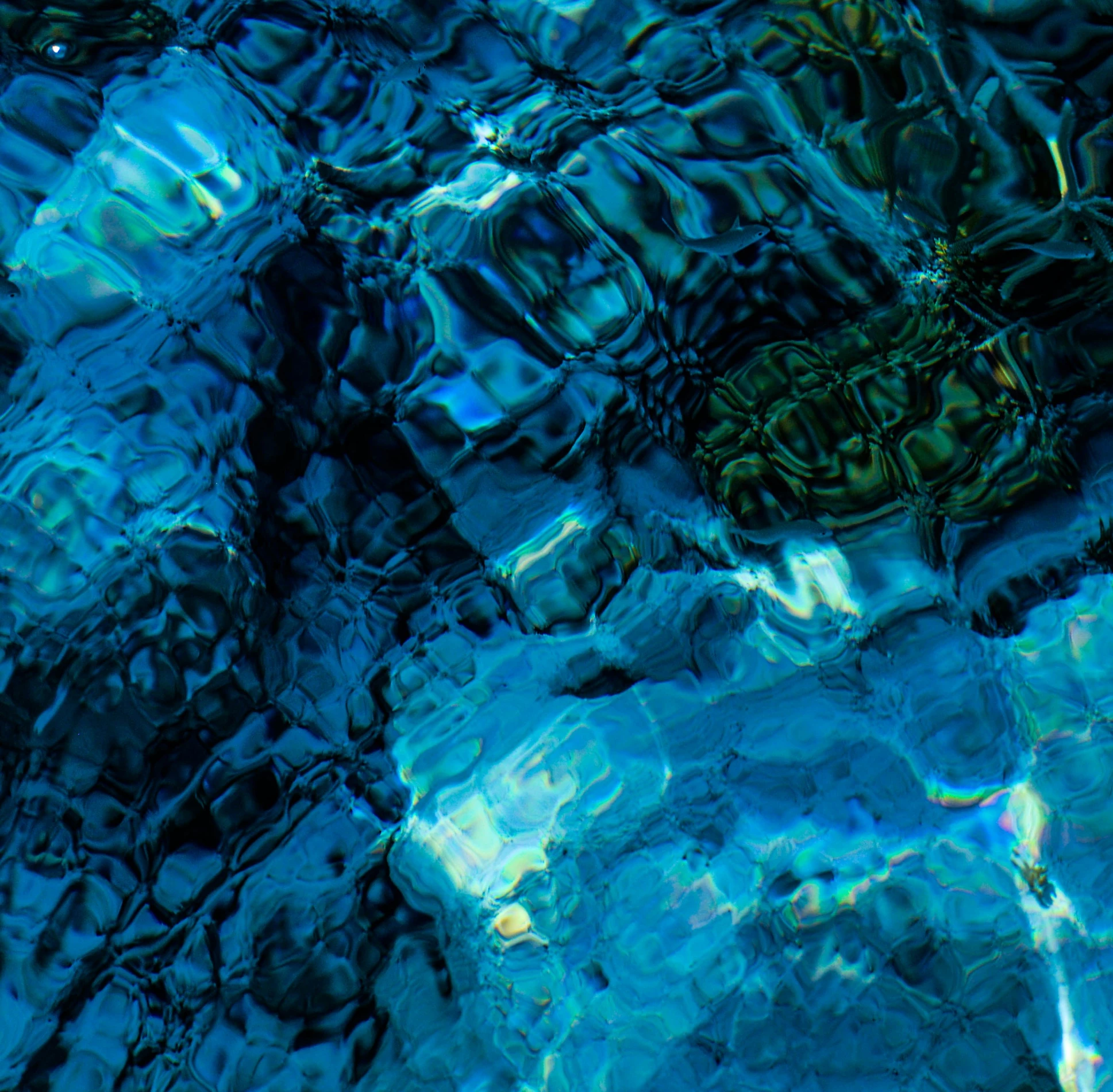 water reflecting off of the surface of a pool