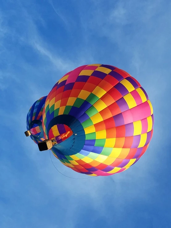  air balloon against a blue sky with puffy clouds