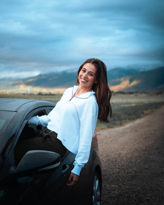 the woman is leaning out of the car