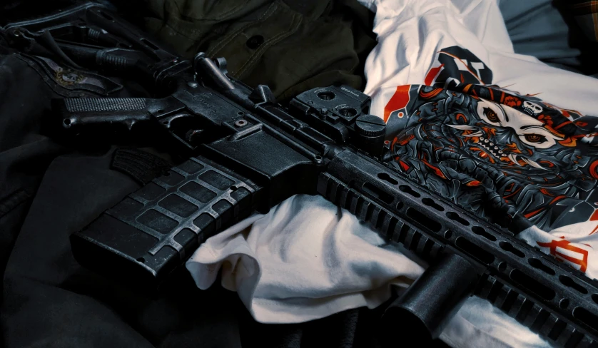 a close up image of a gun, glove and clothes
