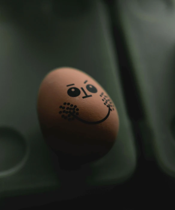 a black and white po with an image of a face painted on an egg