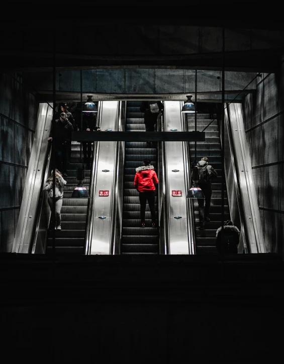 a person standing at an escalator that has metal stairs