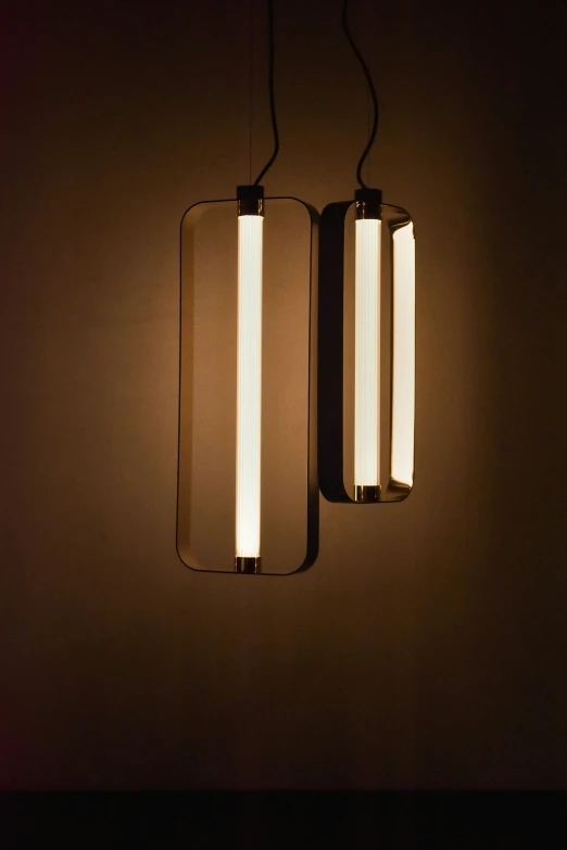 two pendant lights that are sitting on the wall