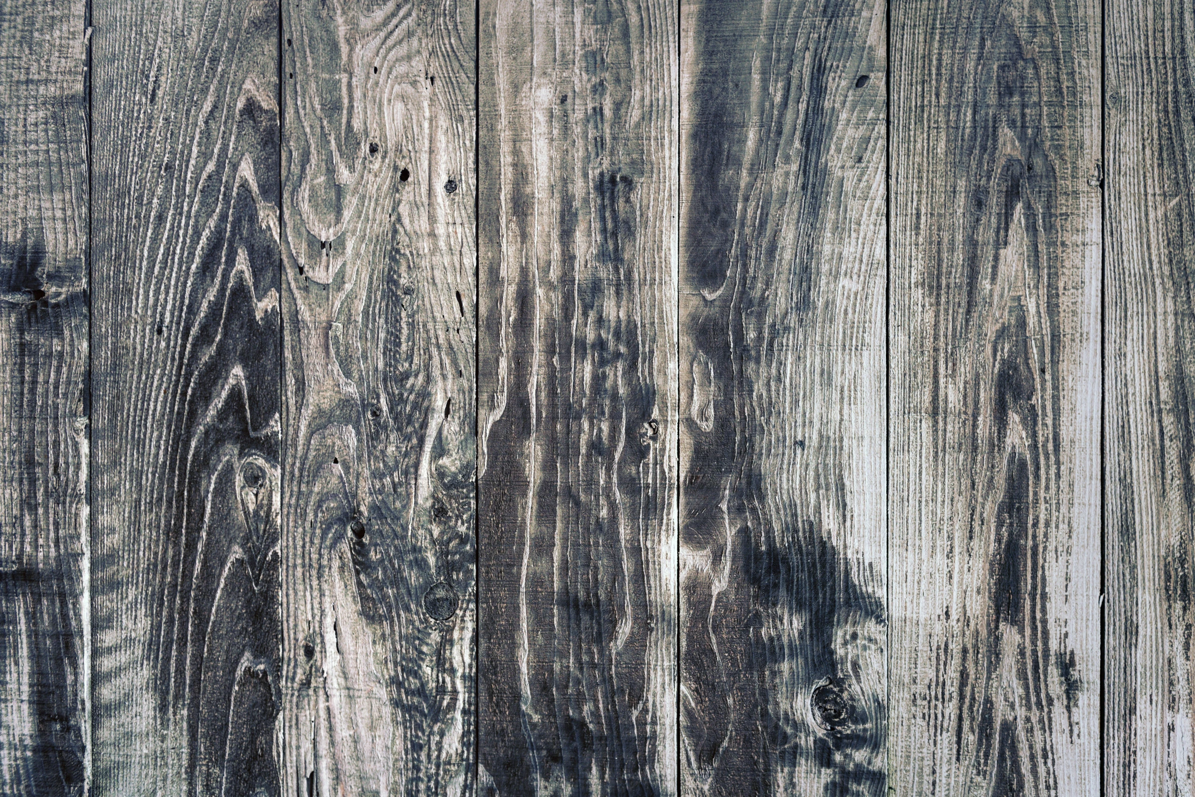 a white wood plank wall with very rough boards