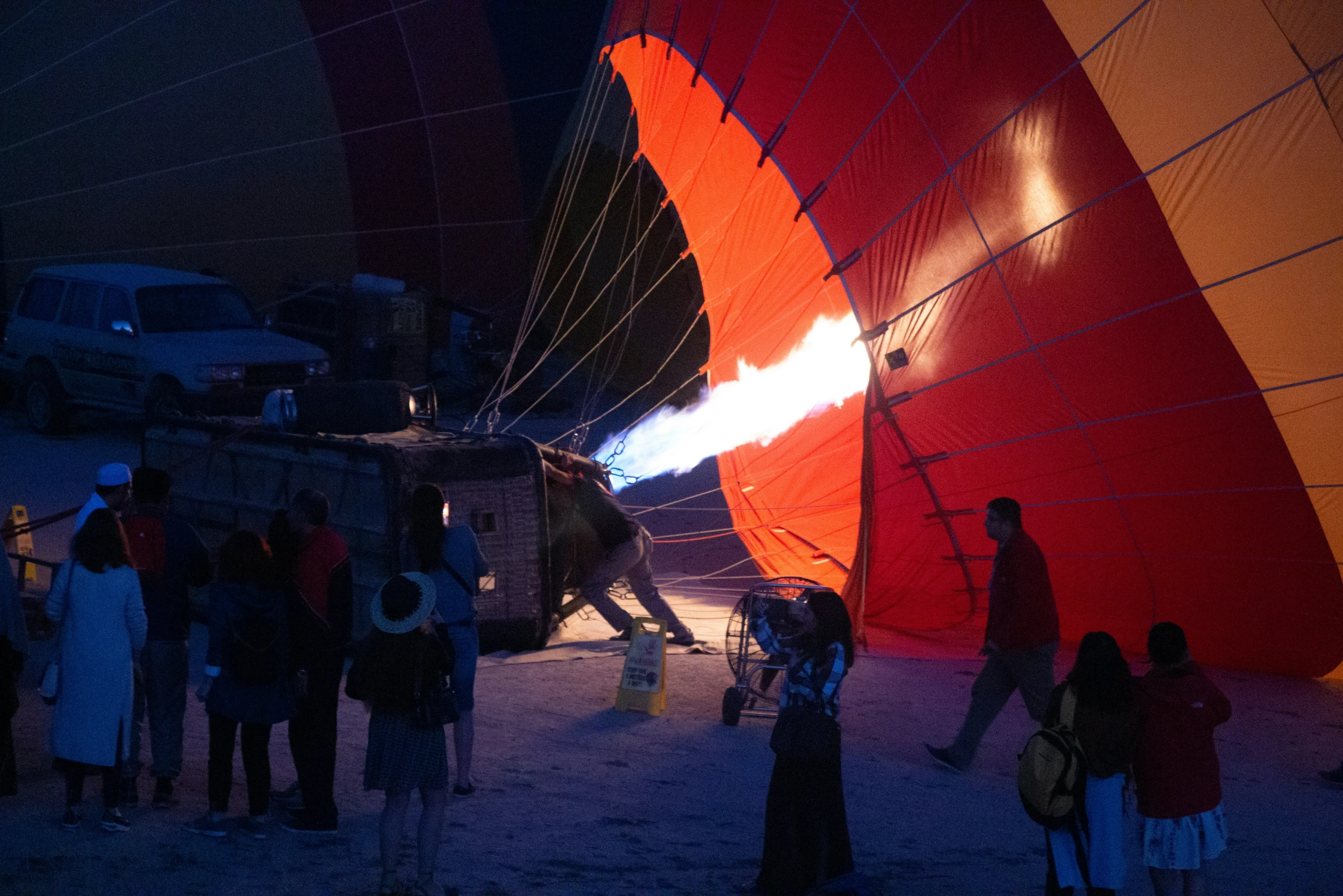 people standing around and inside of  air balloons