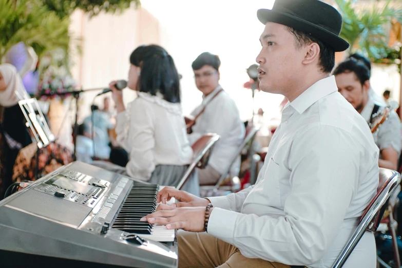 a man is playing music outside on a piano