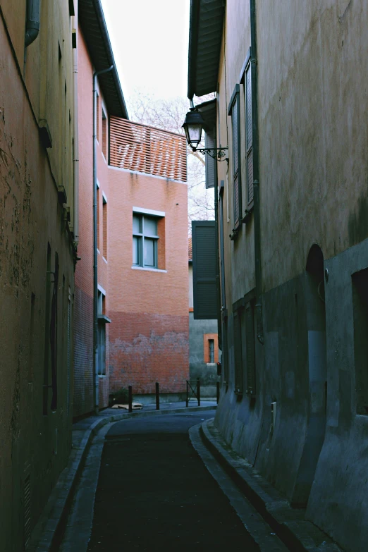 a long alley between two buildings with windows