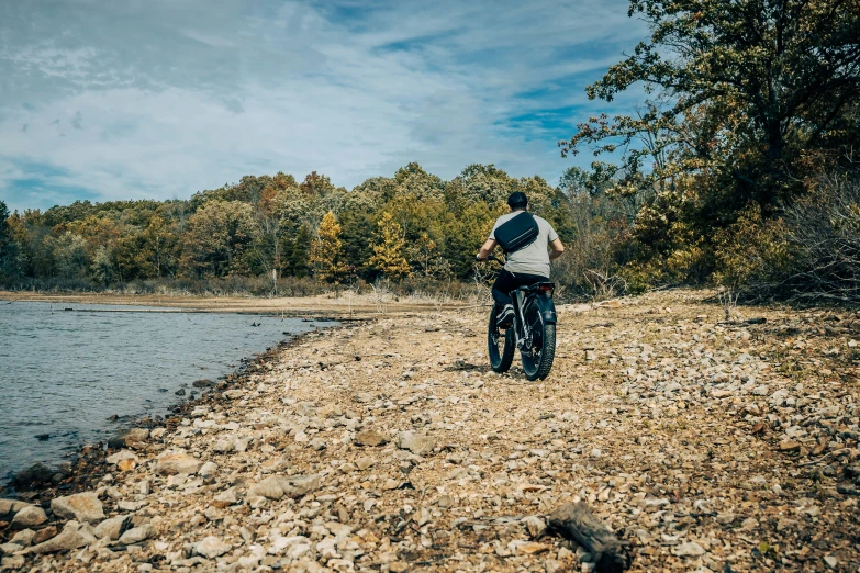 a man that is standing up with his bike