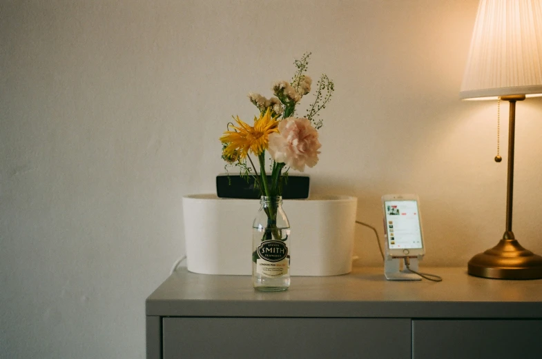 a vase on a table with flowers in it