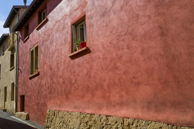 the window of an orange building near some cars