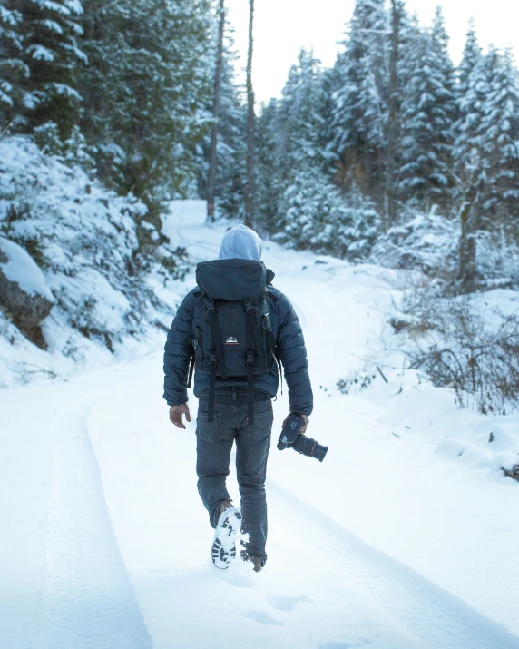 a man walks on snow in the forest