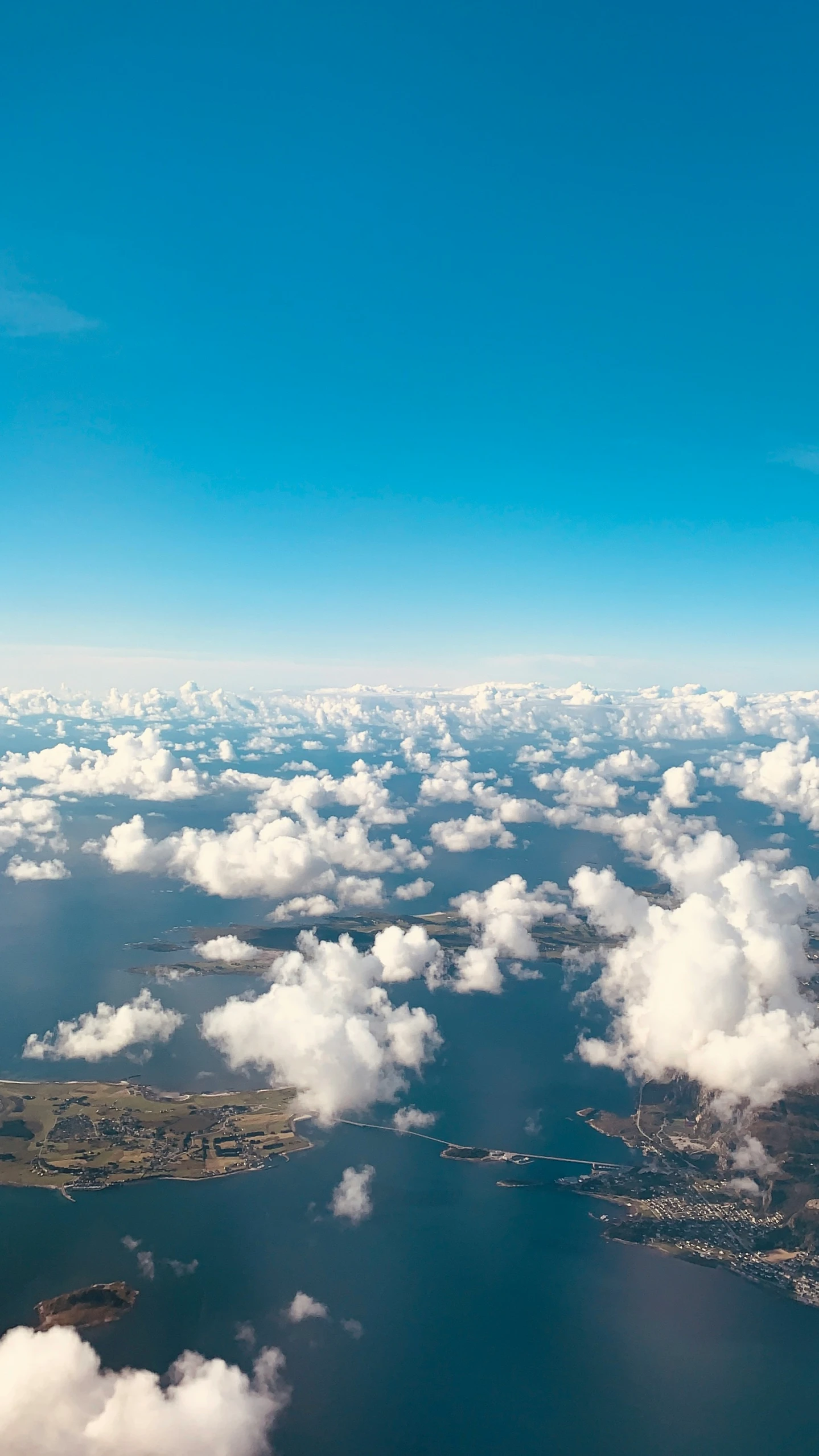 an airplane that is flying above some clouds