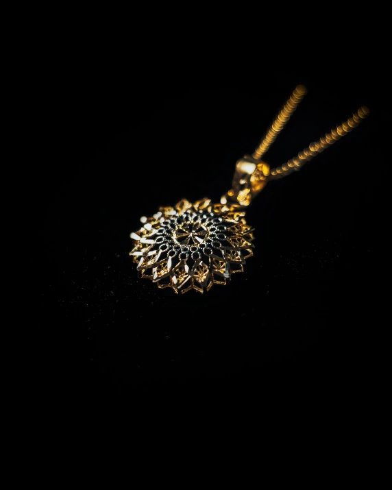 necklace with golden tone setting on dark surface