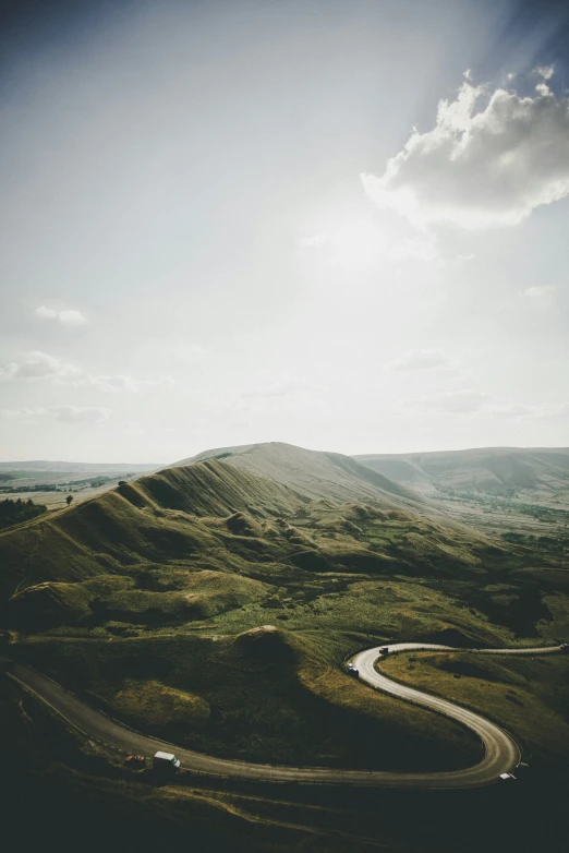 the road winding through the lush green mountains