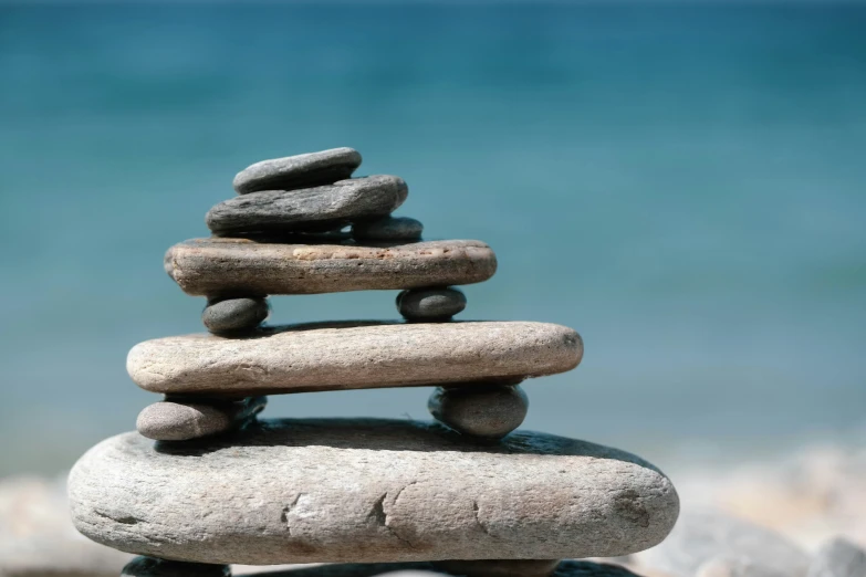 a close up of rocks with water in the background