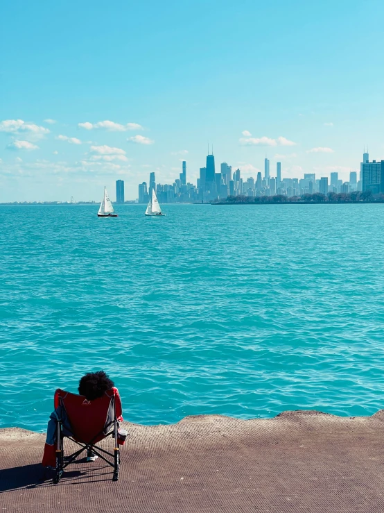 the beach chair is facing towards the city skyline