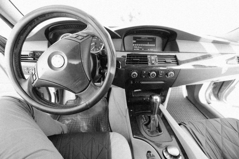 black and white image of the interior of a car