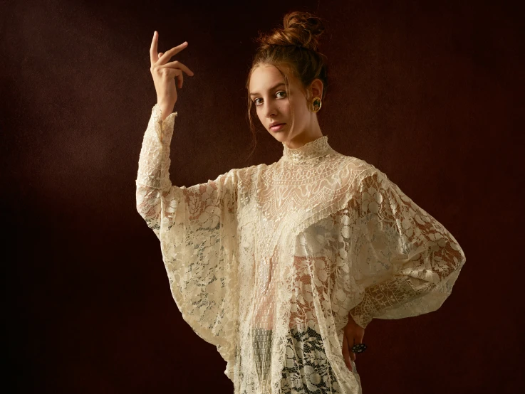 a woman that is standing in front of a dark background