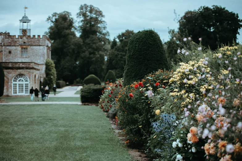 an exterior view of a building with flowers in front