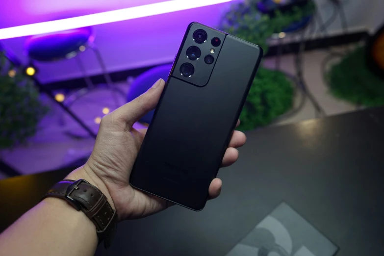 the black phone has a camera attached to it