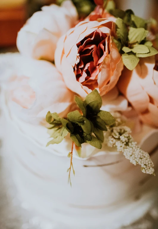 a bouquet of flowers are sitting on top of a cake