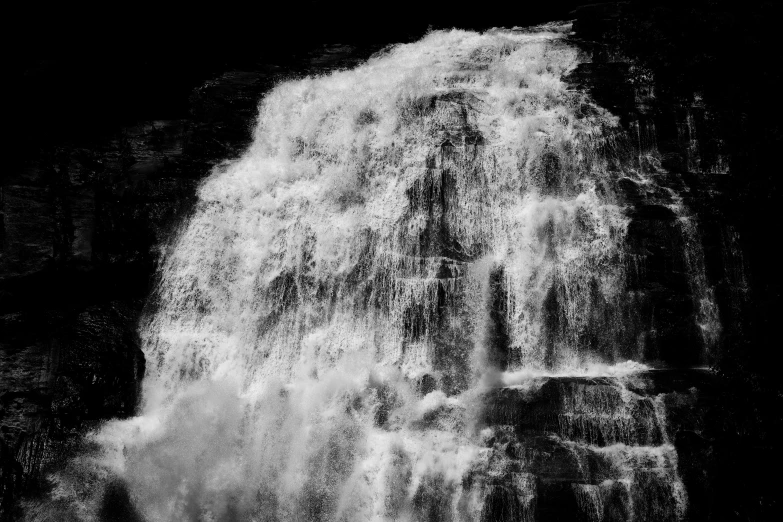 waterfall in the night with small black dots