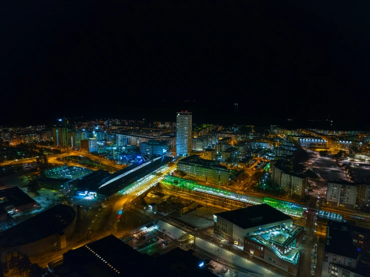 a po taken from the air at night time shows buildings and a highway