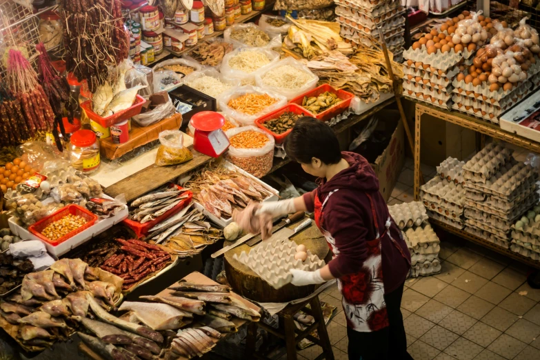 woman buying items from an outdoor produce market