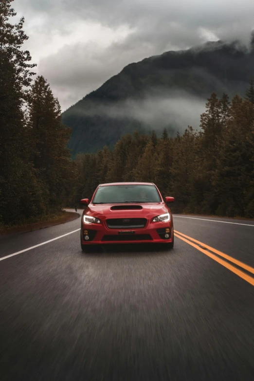 a car driving down the road on a cloudy day