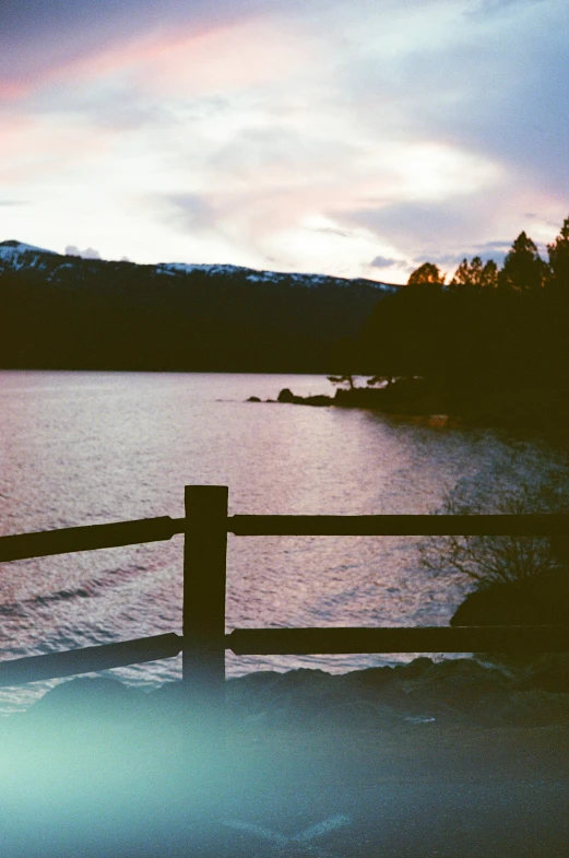 a body of water with snow on the ground