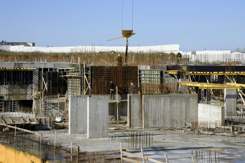 an unfinished building with crane and crane in the foreground