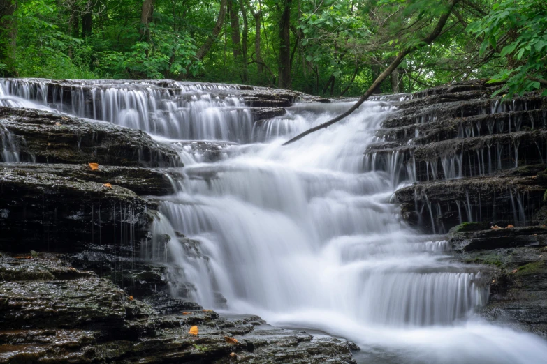 water flows through the rocks into a small waterfall