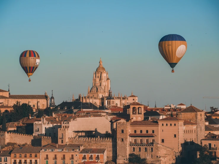 there are  air balloons flying over the city