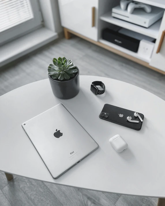 a table topped with an apple computer and accessories