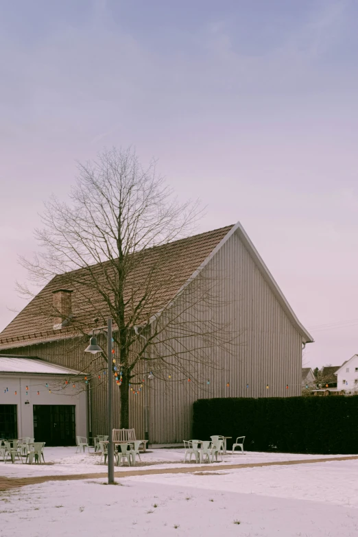 a barn and yard are covered in snow