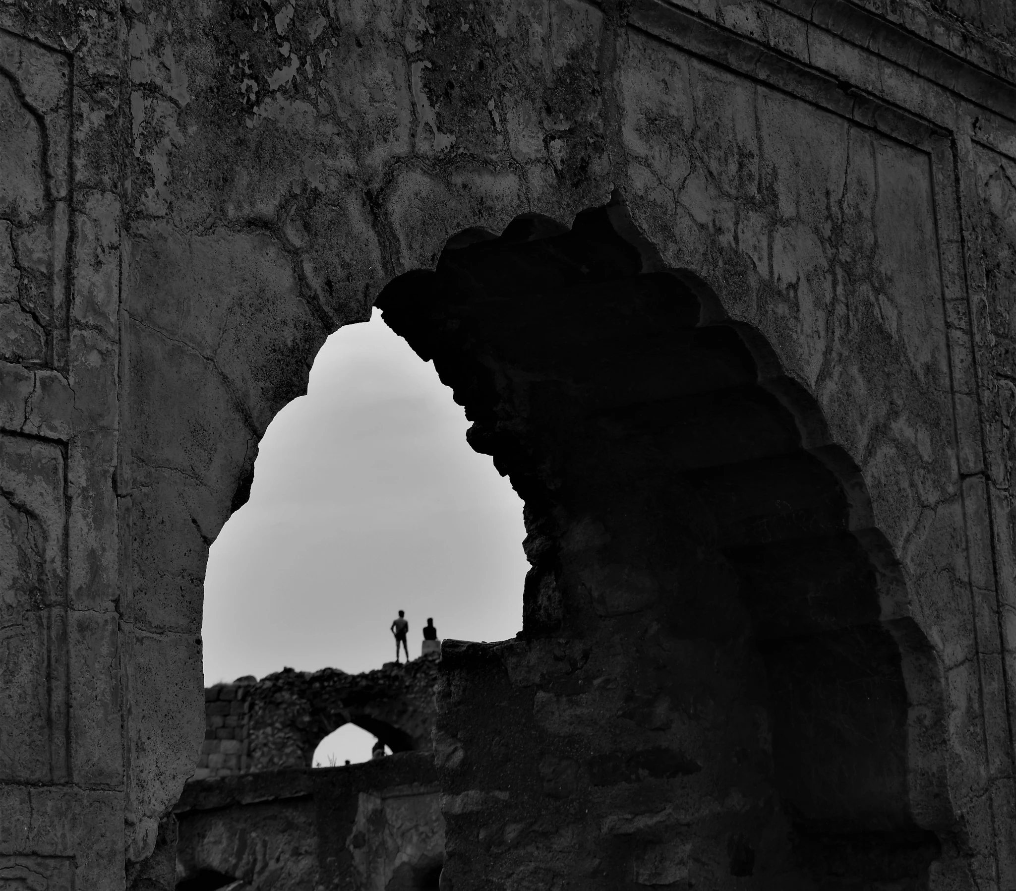 two people are standing in an old building