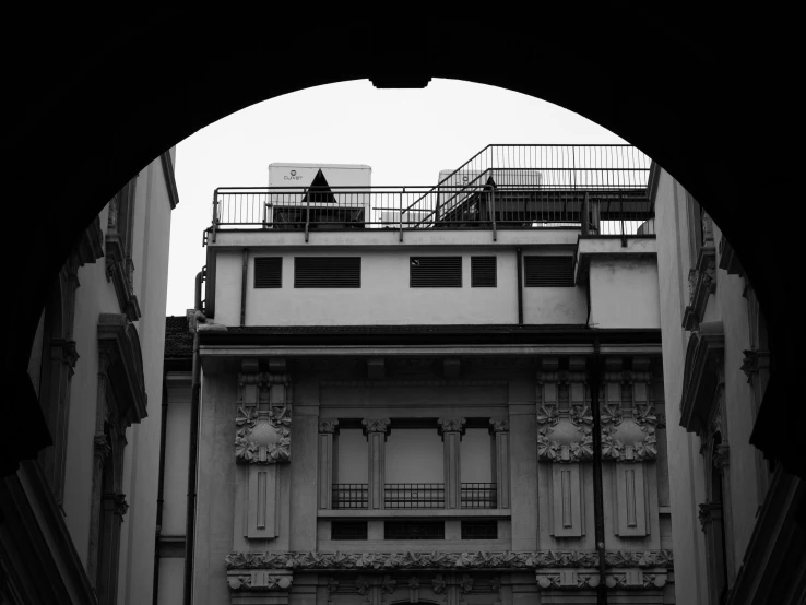 a tall white building with lots of balconies