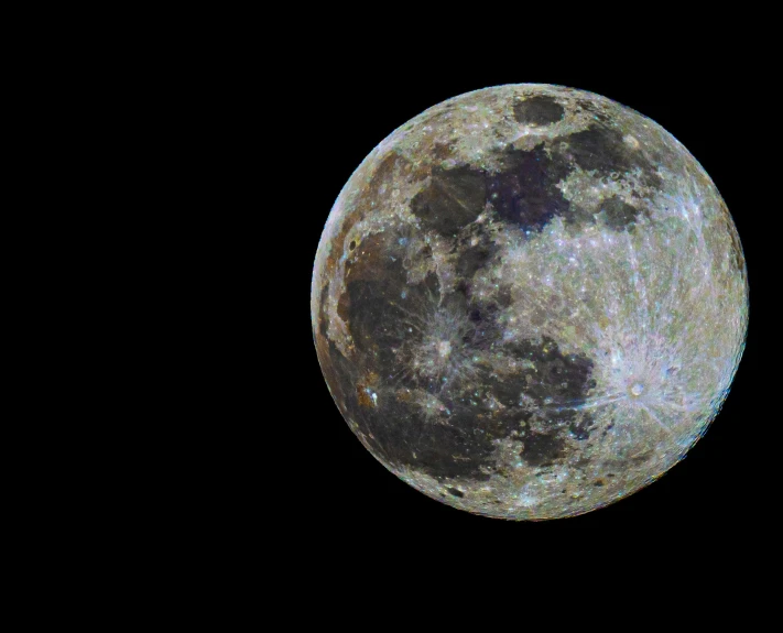 the full moon in the night sky with an airplane flying overhead