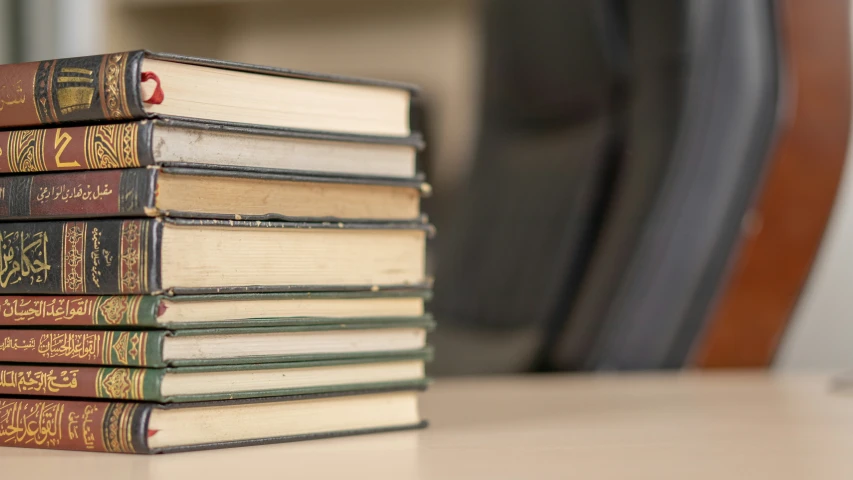 there is a pile of books sitting on the table