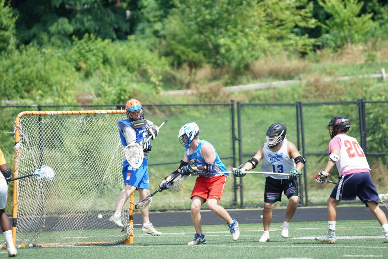 a group of s playing a game of lacrosse