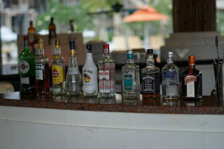 a table with a lot of empty liquor bottles on it