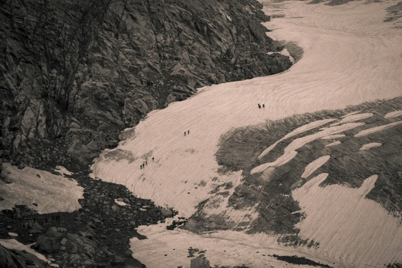 a view of people riding horses down a steep hill